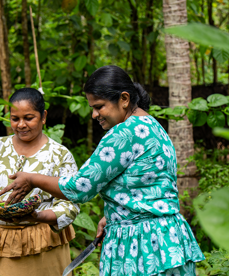 Local hosts preparing food in a village garden
