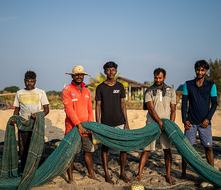 Fishermen with their nets on the beach