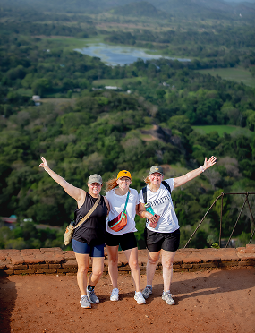 Travellers celebrating above a jungle viewpoint